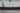 A man walking past a train.