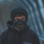 a man wearing a black mask and a black hoodie