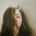 woman with blonde hair in front of white wall