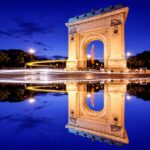 brown concrete arch near body of water during daytime