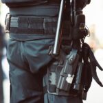 a man holding a gun and a gun holster