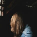 person sitting beside window