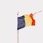 a flag is flying on top of a building