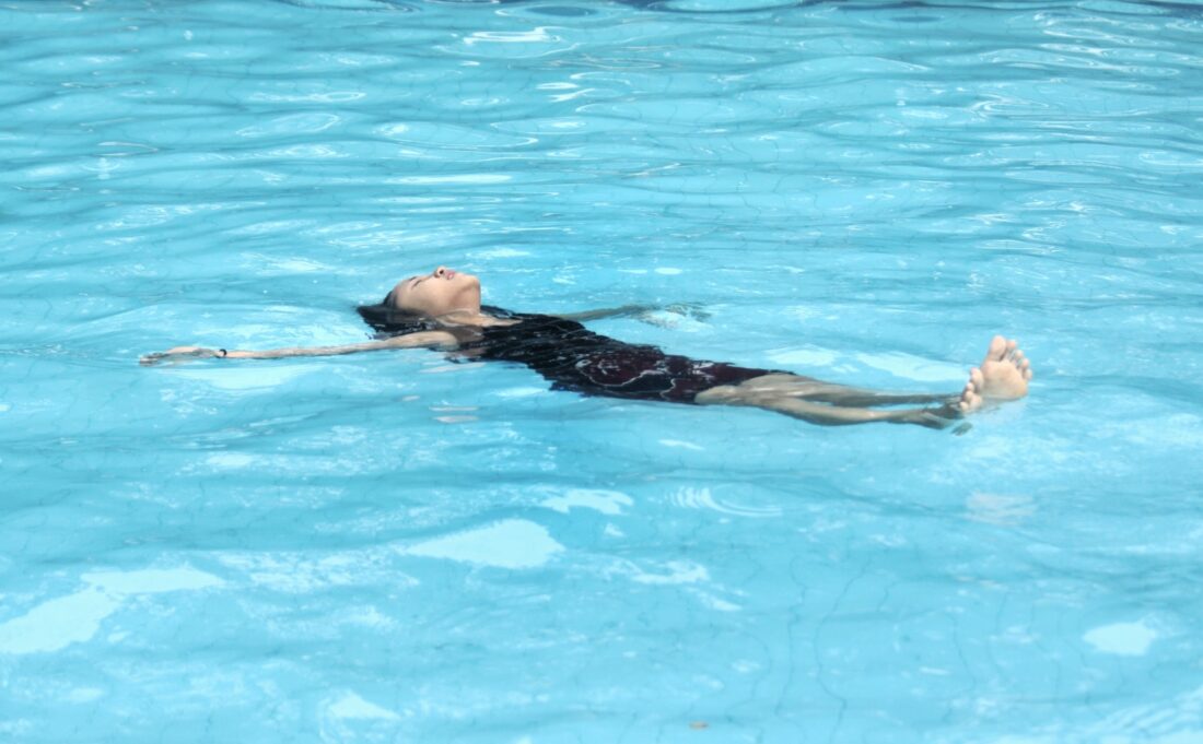 woman in black and white floral swimsuit in water